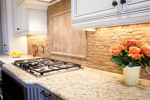 Haystack Travertine Backsplash and Tumbled Travertine Diagonal Tiles Inlay with Giallo Ornamental Granite Countertop and White Cabinets